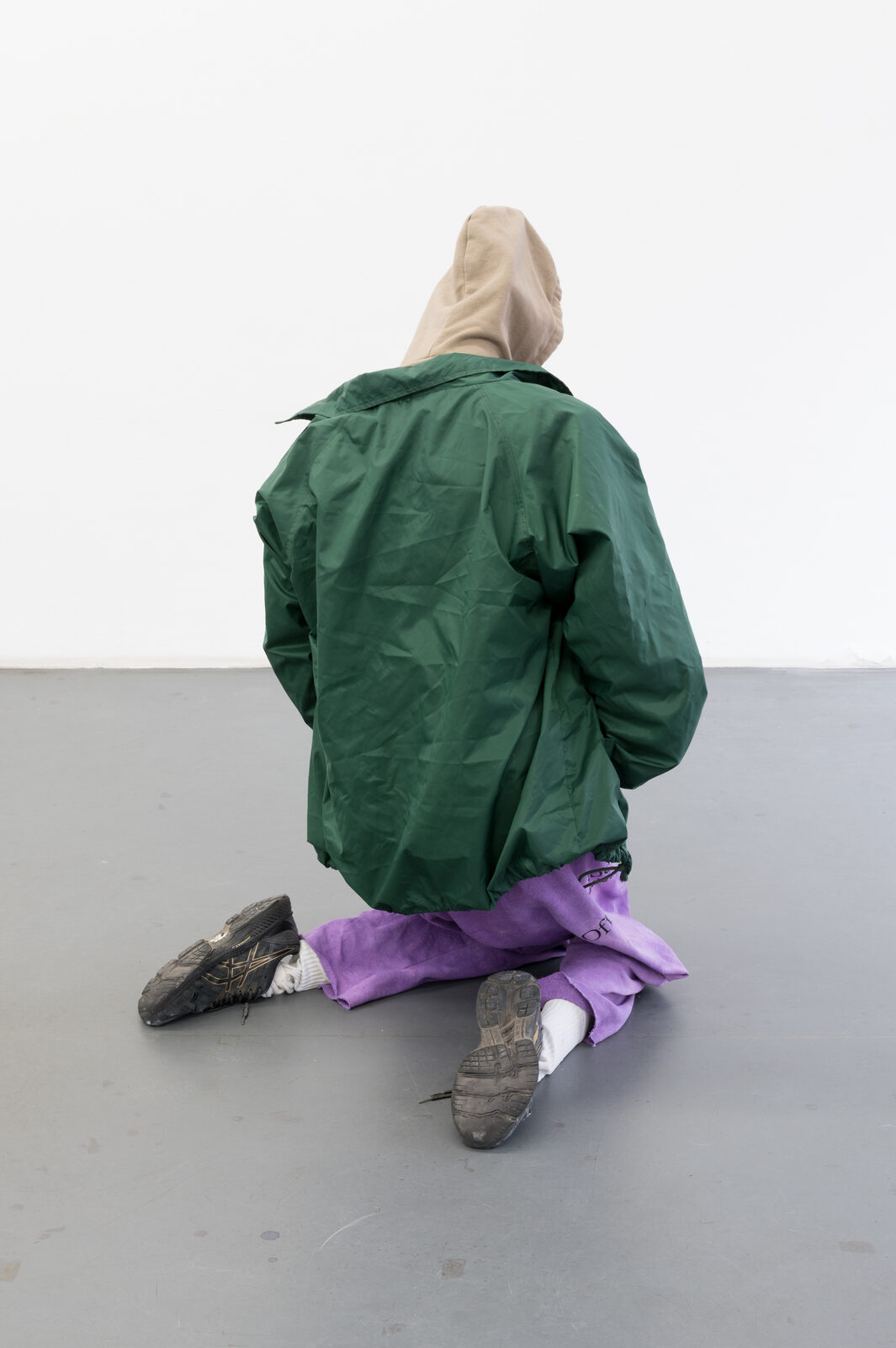 Bliss, mannequin figure kneeling, back view